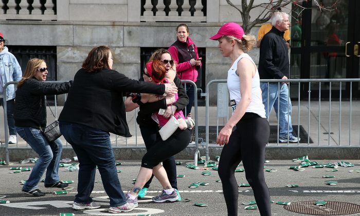 A runner embraces another woman near Kenmore Square after three bombs exploded during the 117th Boston Marathon on April 15, 2013 in Boston, Massachusetts. (Alex Trautwig/Getty Images) 