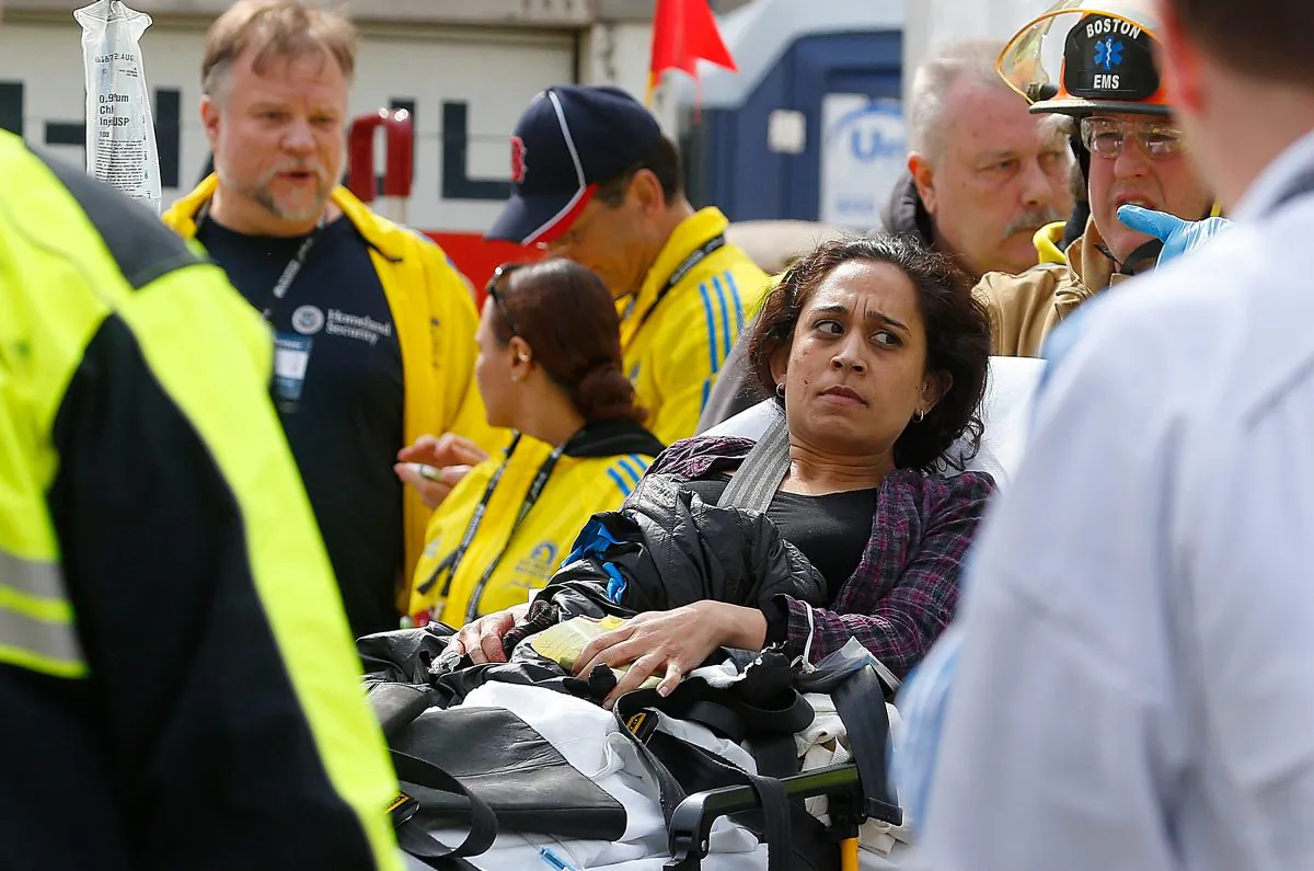 A woman is loaded into an ambulance after she was injured by one of three bombs exploded during the 117th Boston Marathon near Copley Square on April 15, 2013 in Boston, Massachusetts. (Jim Rogash/Getty Images)