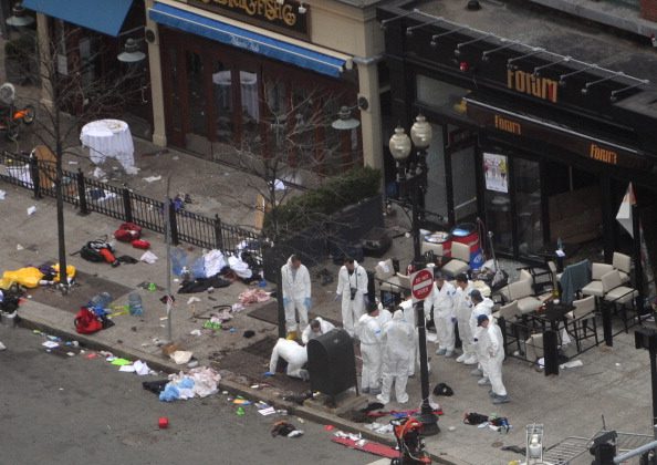 nvestigators in white jumpsuits work the crime scene on Boylston Street following yesterday's bomb attack at the Boston Marathon April 16, 2013 in Boston. (Darren McCollester/Getty Images)