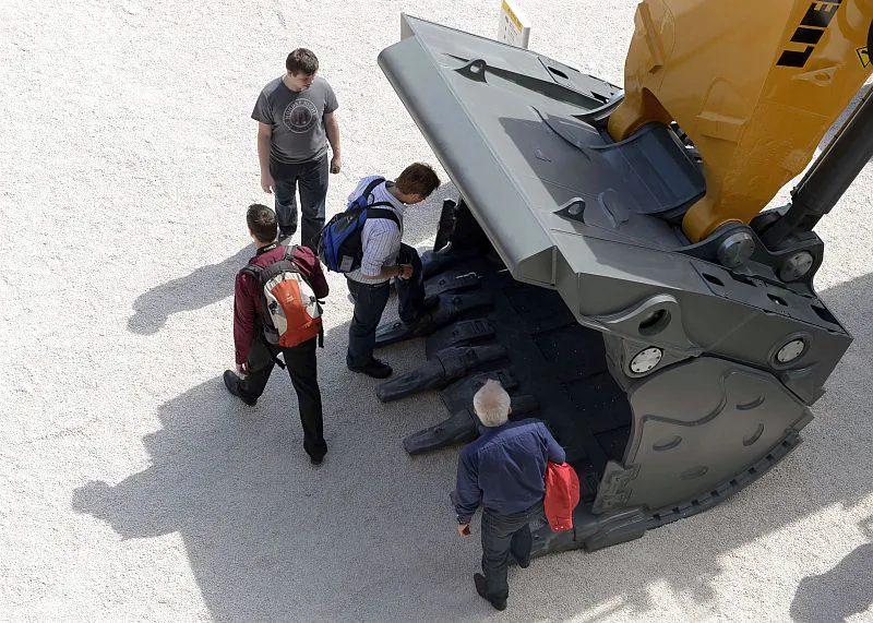 Visitors look at an excavator shovel at an international trade fair in Munich, Germany, on April 18, 2013. The mining industry relies on massive equipment supplied by a handful of foreign companies, controlled under tight maintenance contracts that historically have not benefited local parties, writes Will Hickey (Christof Stache/AFP/Getty Images) 