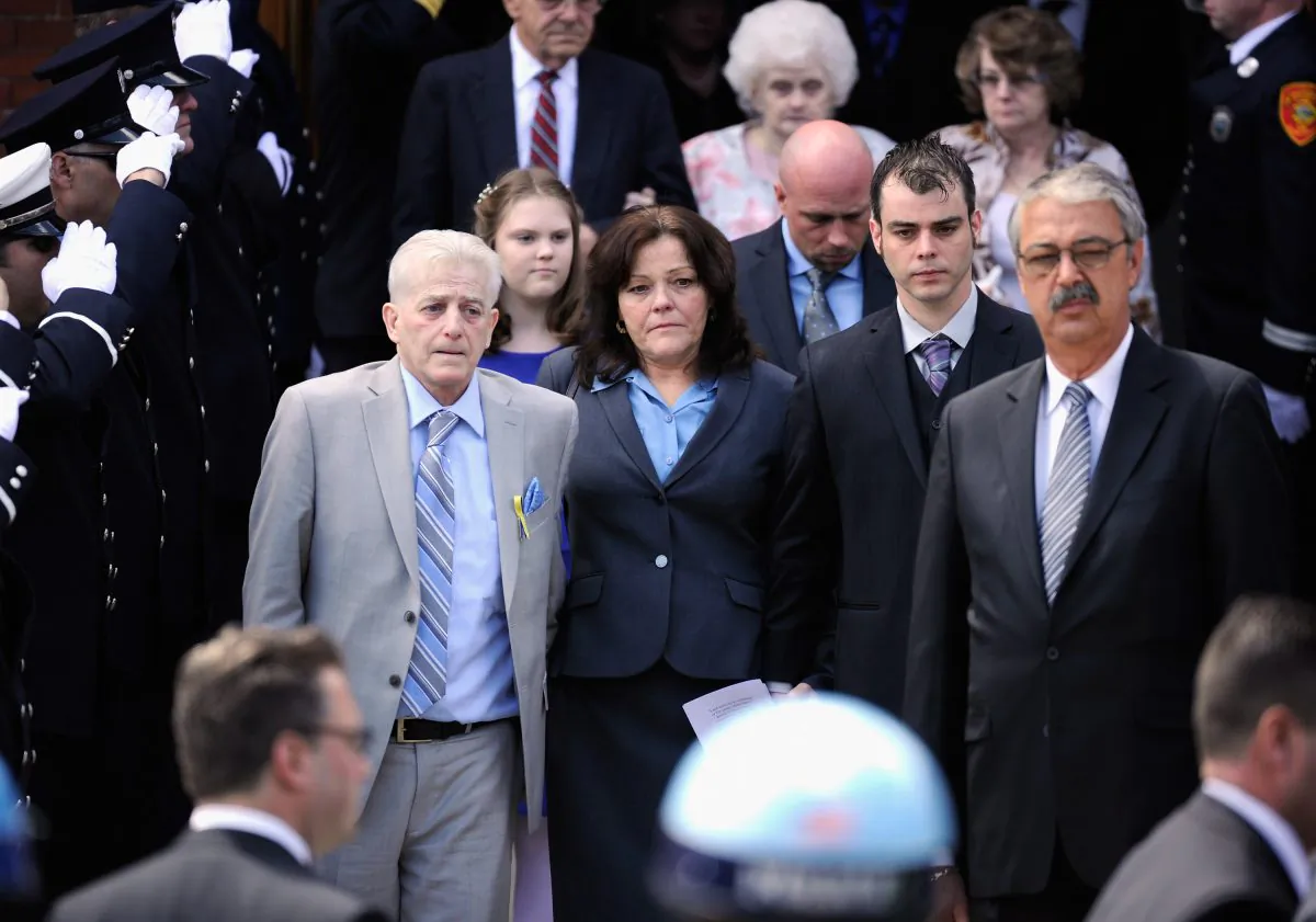 Patty Cambell (3rd L), mother of Krystle Campbell, a victim of the Boston Marathon bombing, and brother Billy Campbell (2nd R) walk out of St. Joseph Catholic Church after the funeral service on April 22, 2013 in Medford, Massachusetts. (Kevork Djansezian/Getty Images)