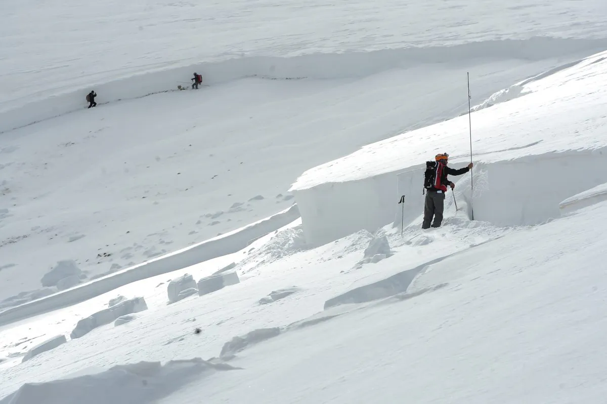 Scott Toepfer, right, a member of the Colorado Avalanche Information Center or CAIC, takes depth measurements every 50 feet at the crown of an avalanche on April 21, 2013. Snow sports are risky, but there are ways to lesson the risk. (AP Photo/The Denver Post,Helen H. Richardson)