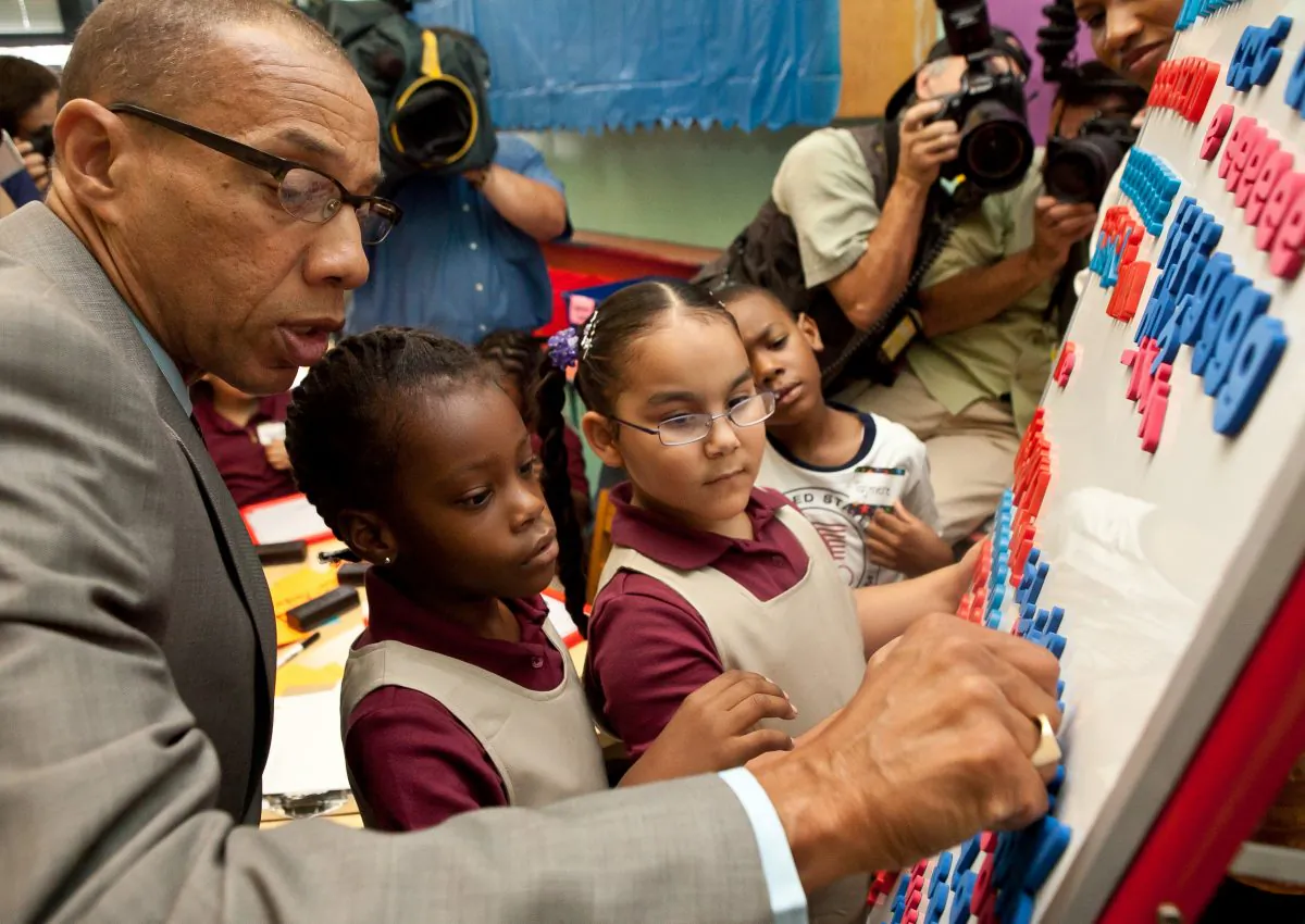 Schools Chancellor Dennis Walcott with first-grade children from the Young Scholar’s Academy for Discovery and Exploration school on the first day of school in Brooklyn on Sept. 6, 2012. (Amal Chen/The Epoch Times)