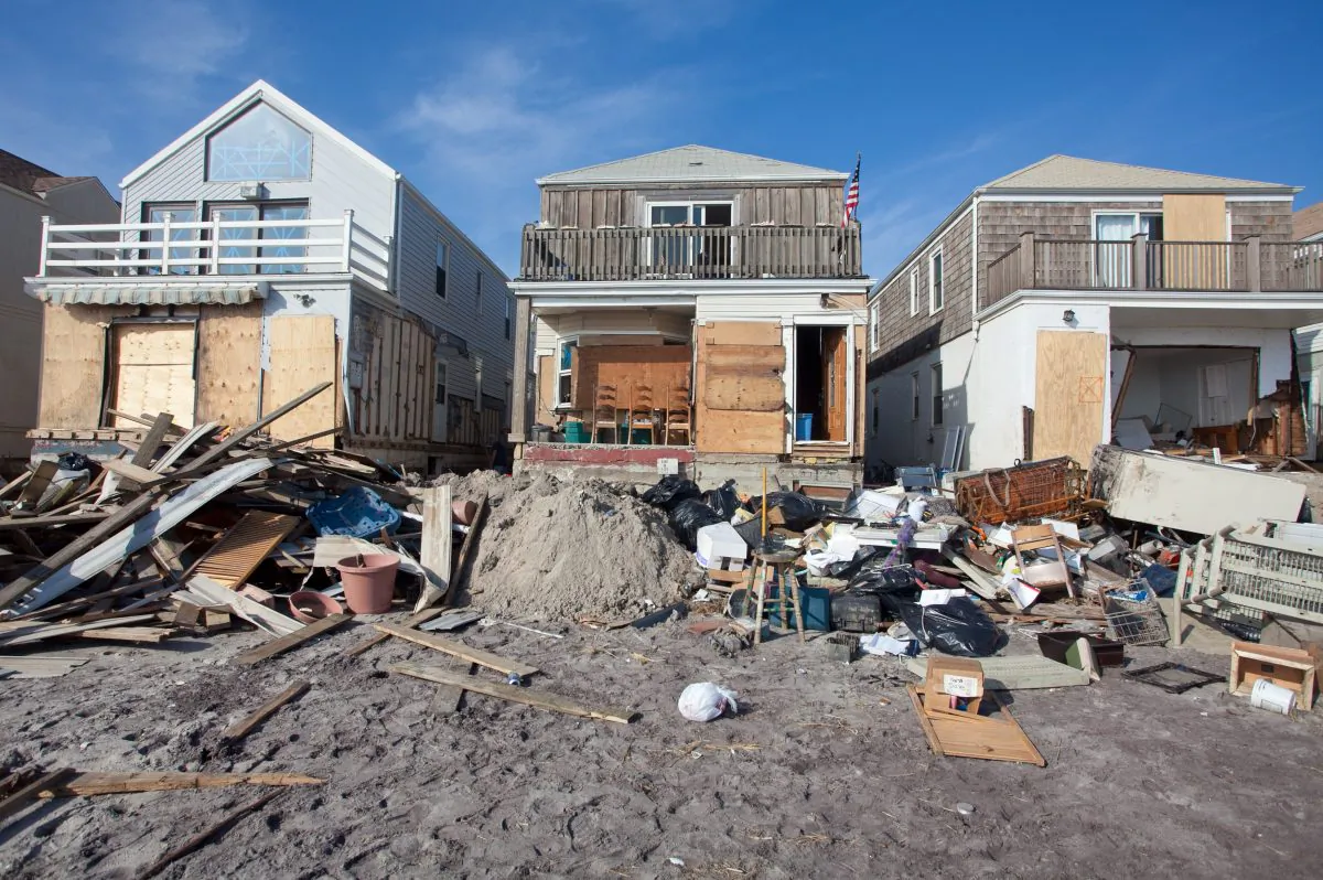 The beachfront home (middle) of Bill Guage, a 64-year-old nurse, was slammed with water and sand during Superstorm Sandy. Candidates to be the next New York City debated whether to rebuild waterfront areas and also discussed expanding the ferry system. (Amal Chen/The Epoch Times)