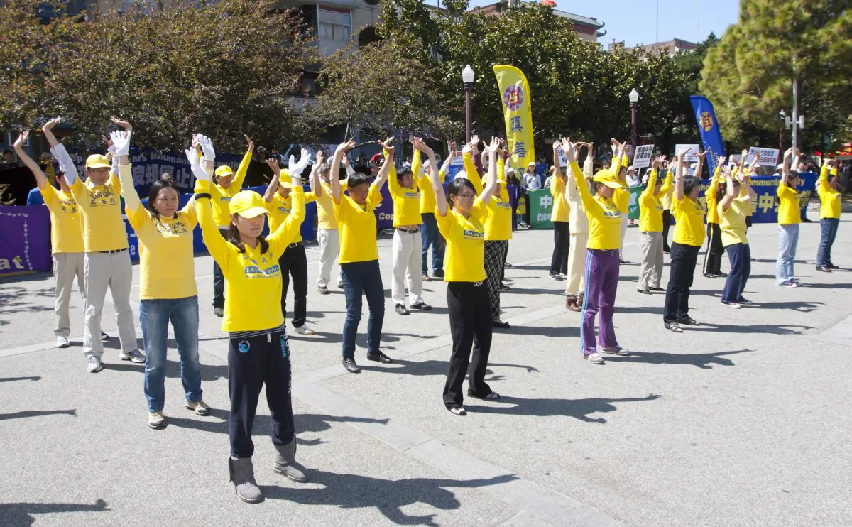 Falun Gong practitioners demonstrate the first exercise during a rally to commemorate “April 25” in San Francisco’s Chinatown on April 21, 2013. More than 10,000 practitioners gathered in central Beijing on April 25, 1999, to protest the discrimination of their practice in the largest demonstration since the Tiananmen Square protests. (Alex Ma/The Epoch Times)