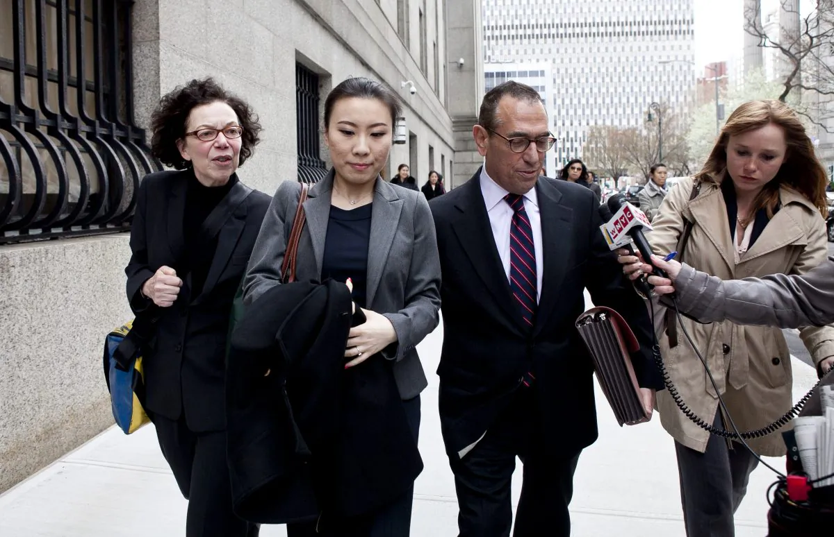 Comptroller John Liu’s treasurer, Jenny Hou (C) exits the the United States District Court in Manhattan with her lawyers Jarold Lefcart (R) , Sheiyrl Reich (L) in New York on April 16. (Samira Bouaou/The Epoch Times)