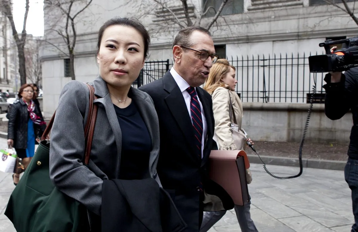 Comptroller John Liu’s treasurer, Jenny Hou (L) exits the United States District Court in Manhattan with lawyer Jarold Lefcart (R) in New York on April 16. (Samira Bouaou/The Epoch Times)