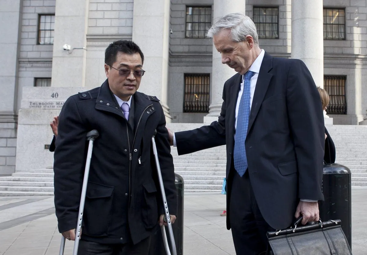 A former fundraiser for comptroller John Liu, Oliver Pan, in front of the United States District Court in Manhattan with his lawyer Gregory Ryan on April 16 in New York. (Samira Bouaou/The Epoch Times)