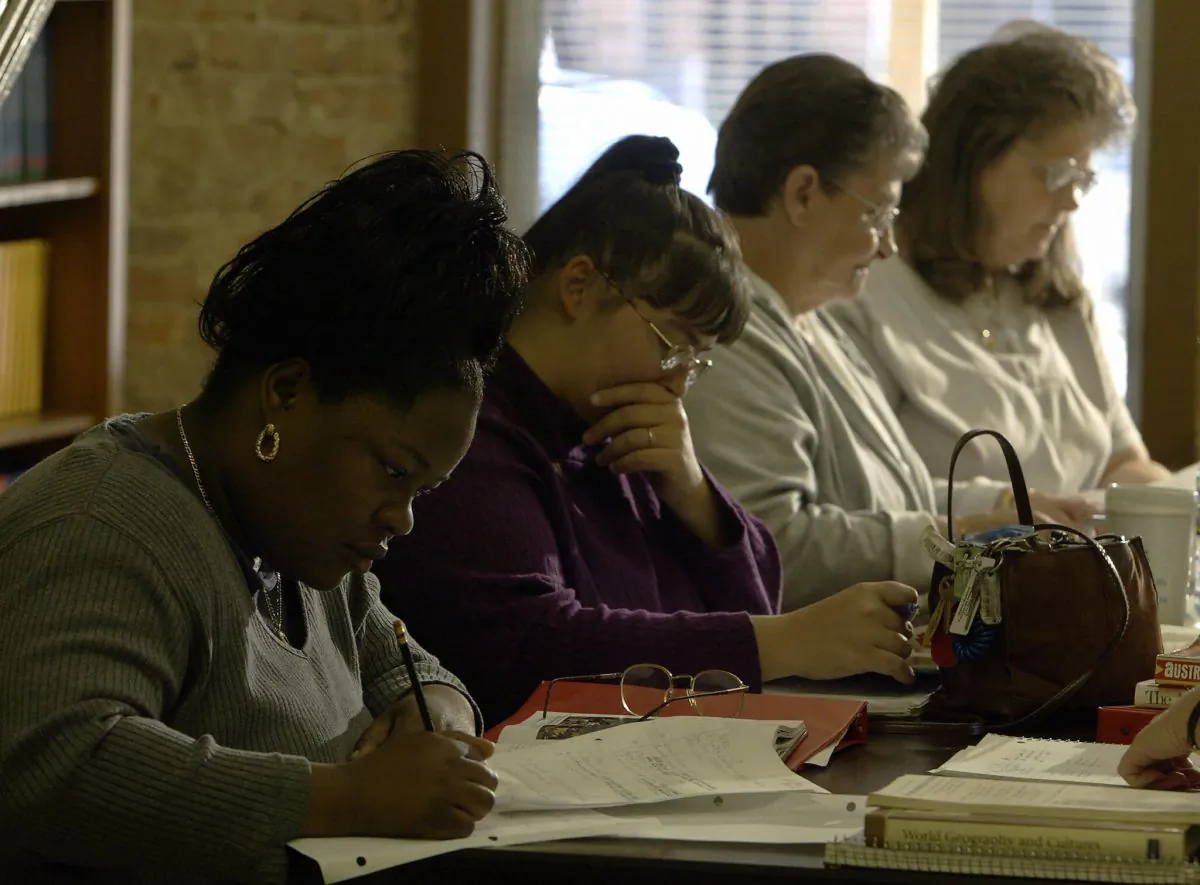 Eela Cox, (L),33, studies world geography at the Adult Basic Education office in Lumberton, North Carolina, in this file photo with other women who brushing up on basics to enable them to get their GED or High School diploma. States across the country are developing alternatives to the GED. (Paul J. Richards/AFP/Getty Images) 