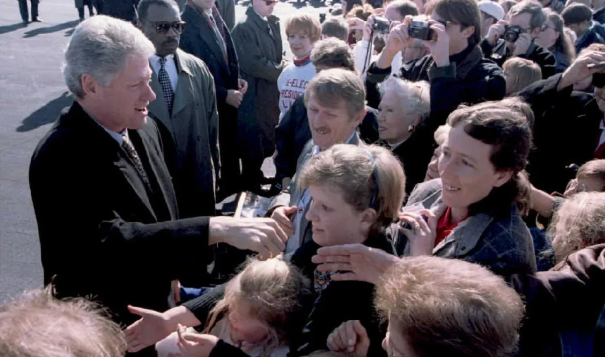Then-president Bill Clinton (L) greets people in 1995 at the airport in Little Rock, AK. The airport was recently renamed after Bill and Hilary Clinton, who will attend a ceremony marking the first phase of renovations.(Luke Frazza/AFP/Getty Images)
