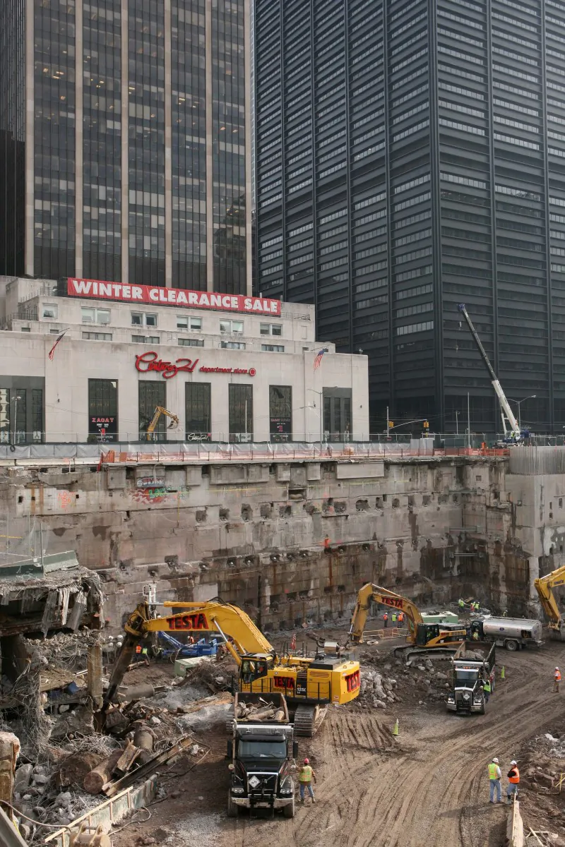 Construction workers and equipment excavate the southeastern corner of the World Trade Center site on in this Jan. 8, 2008, file photo taken in New York. About 60 truckloads of debris that could contain tiny human bone fragments have been unearthed by construction crews working on the new World Trade Center tower in recent years. (AP Photo/Mark Lennihan, File)