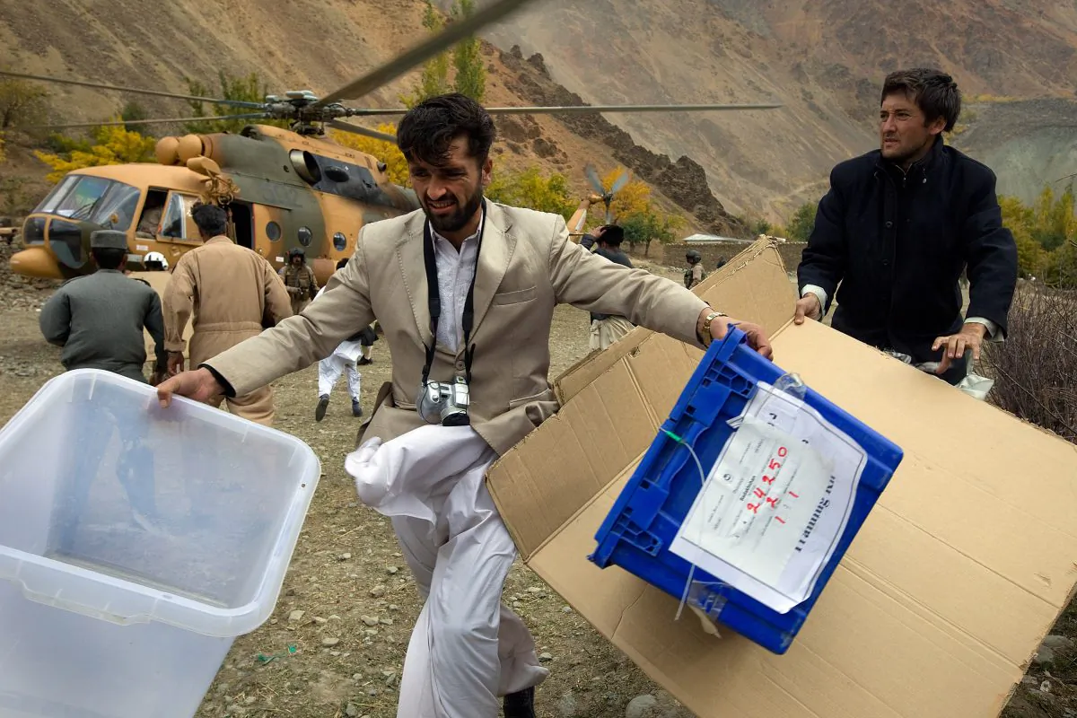 Afghan electoral commission workers unload election material from a helicopter on Nov. 1, 2009, in the remote village of Kofab, Afghanistan. The 2009 election was wrought with fraud, which observers hope will not be the case in 2015. (Paula Bronstein/Getty Images)