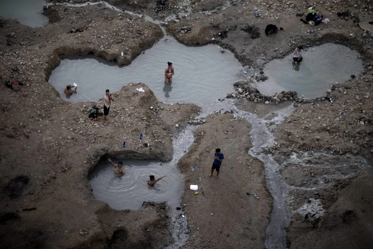 An aerial view of bathers in the hot springs on the shore of the Israeli Dead Sea near Kibbutz Ein Gedi on Nov. 10, 2011. As water levels drop, environmental groups and government agencies seek a way to save the Dead Sea.  (Menahem Kahana/AFP/Getty Images)
