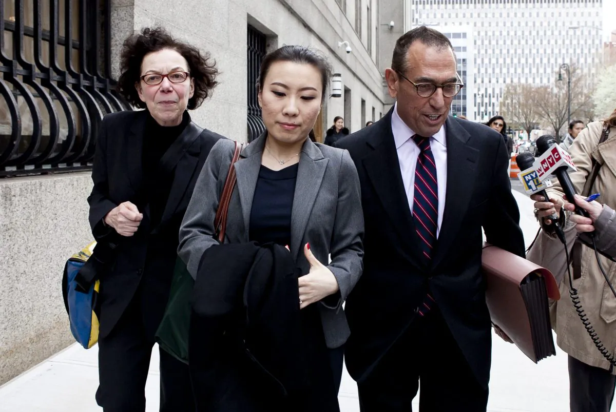 Comptroller John Liu’s treasurer, Jenny Hou (C) exits the the United States District Court in Manhattan with her lawyers Jarold Lefcart (R) , Sheiyrl Reich (L) in New York on April 16. (Samira Bouaou/The Epoch Times)
