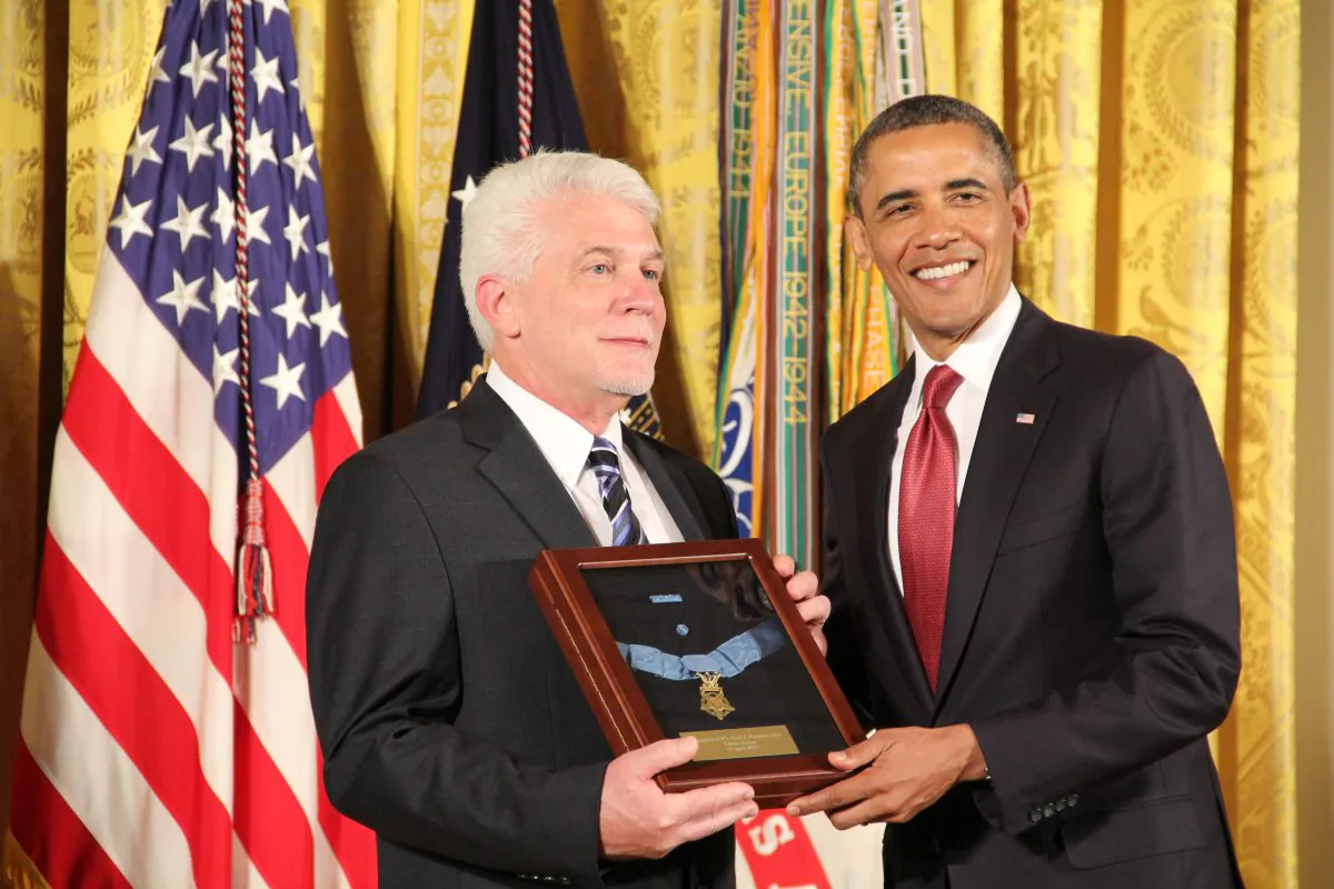 President Barack Obama presents the Medal of Honor, to Ray Kapaun, who as the nephew of deceased Korean War hero Chaplain Emil Kapaun, accepted the award on behalf of his uncle April 11, 2013 at the White House. (Shar Adams/Epoch Times Staff)