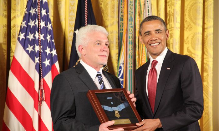 President Barack Obama presents the Medal of Honor, to Ray Kapaun, who as the nephew of deceased Korean War hero Chaplain Emil Kapaun, accepted the award on behalf of his uncle April 11, 2013 at the White House. (Shar Adams/Epoch Times Staff)