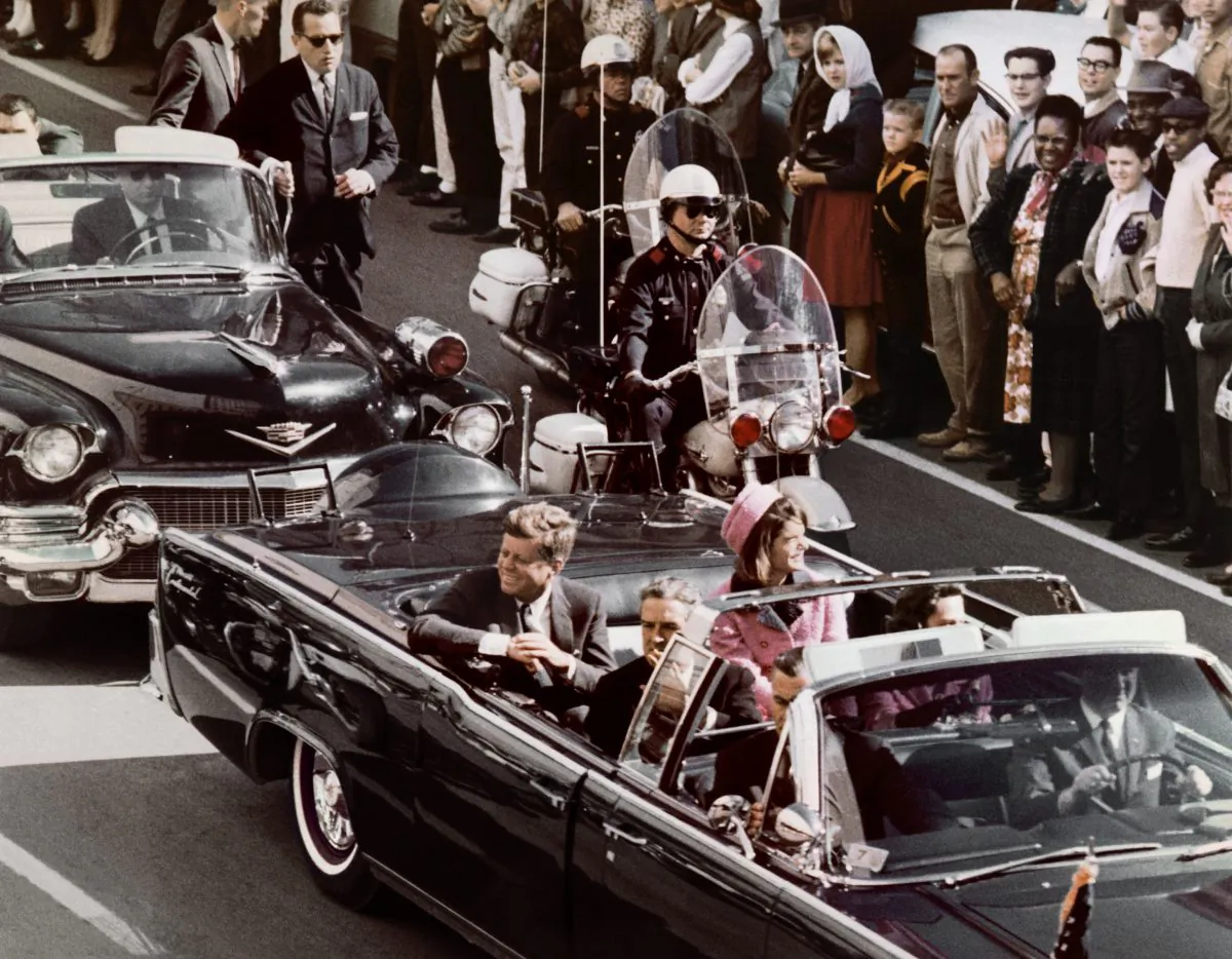 The Kennedys' motorcade drives through downtown Dallas Nov. 22, 1963, moments before the shooting of President John F. Kennedy. (Bettmann/Corbis)