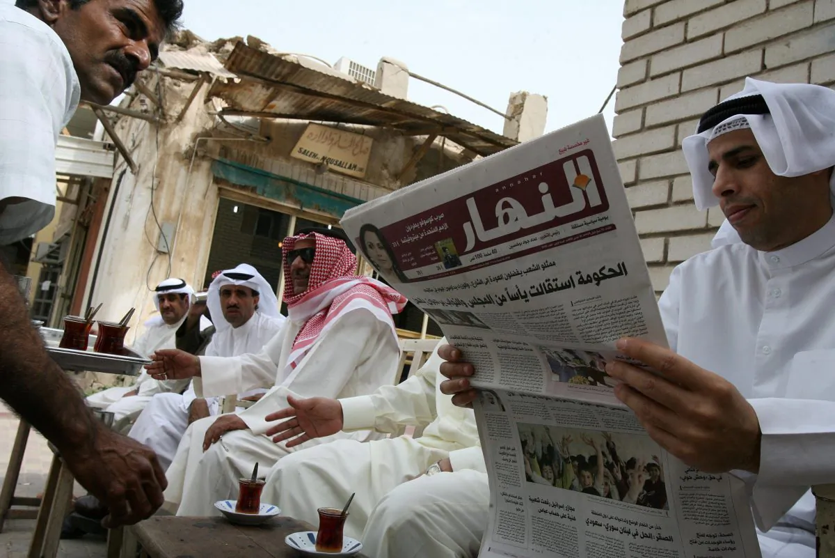 A Kuwaiti man reads a local newspaper as he joins friends at a traditional tea house in Kuwait City's old barzaar on March 18, 2008. (Yasser Al-Zayyat/AFP/Getty Images)