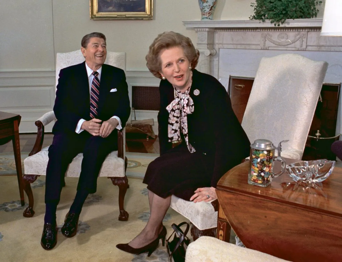 In a file photo from Feb. 20, 1985, former British Prime Minister Margaret Thatcher sits with her friend and political ally President Ronald Reagan during a visit to the White House in Washington. (J. Scott Applewhite/AP Photo)