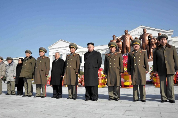 N. Korea warns Embassies: A file photo taken by North Korea's official Korean Central News Agency on February 16, 2013 shows North Korean leader Kim Jong-Un (4th R) and senior senior officials from the party, government and army posing before the statues of late leaders Kim Il-Sung and Kim Jong-Il at Mangyongdae Revolutionary School in Pyongyang.  (KNS/AFP/Getty Images)