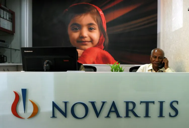 A receptionist sits in the front office of Novartis India in Mumbai on April 1. India's Supreme Court rejected a patent bid by Swiss drug giant Novartis in a landmark ruling that could affect how pharmaceutical firms do business in the emerging markets. (Punit Paranjpe/AFP/Getty Images)