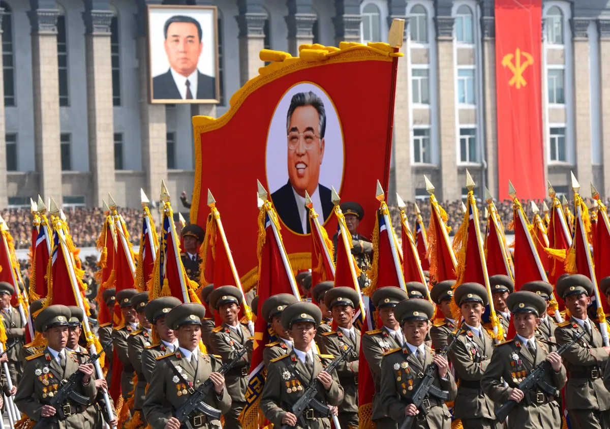 North Korean soldiers march with a portrait of founder Kim Il-Sung on the anniversary of his birth on April 15, 2012. North Korea may launch missiles on April 15, 2013. (Pedro Ugarte/AFP/Getty Images)