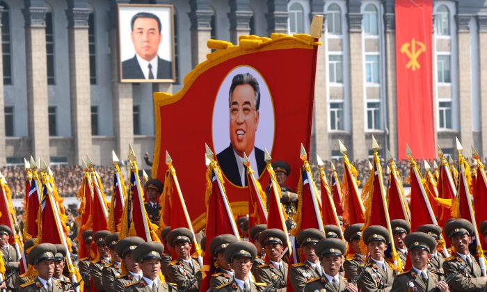 North Korean soldiers march with a portrait of founder Kim Il-Sung on the anniversary of his birth on April 15, 2012. North Korea may launch missiles on April 15, 2013. (Pedro Ugarte/AFP/Getty Images)
