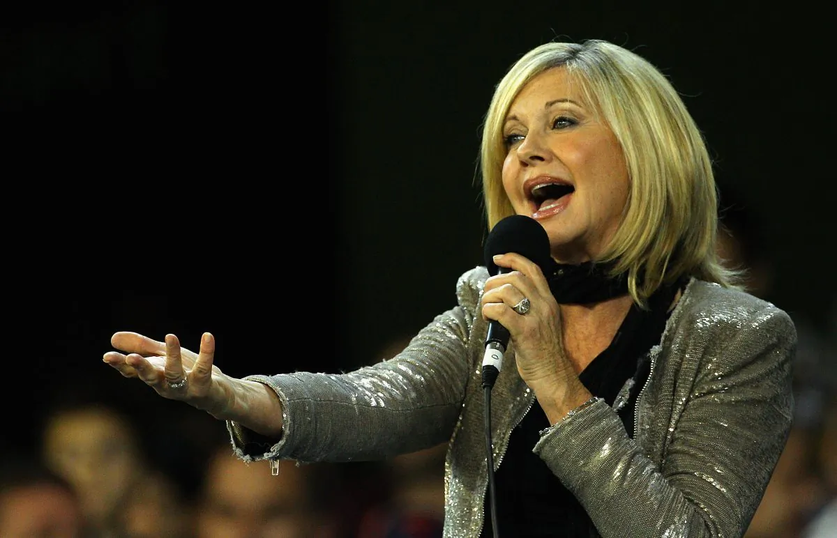 Olivia Newton John performs before a match between the Melbourne Demons and the Carlton Blues at the Melbourne Cricket Ground on May 27, 2011, in Melbourne, Australia. (Quinn Rooney/Getty Images)
