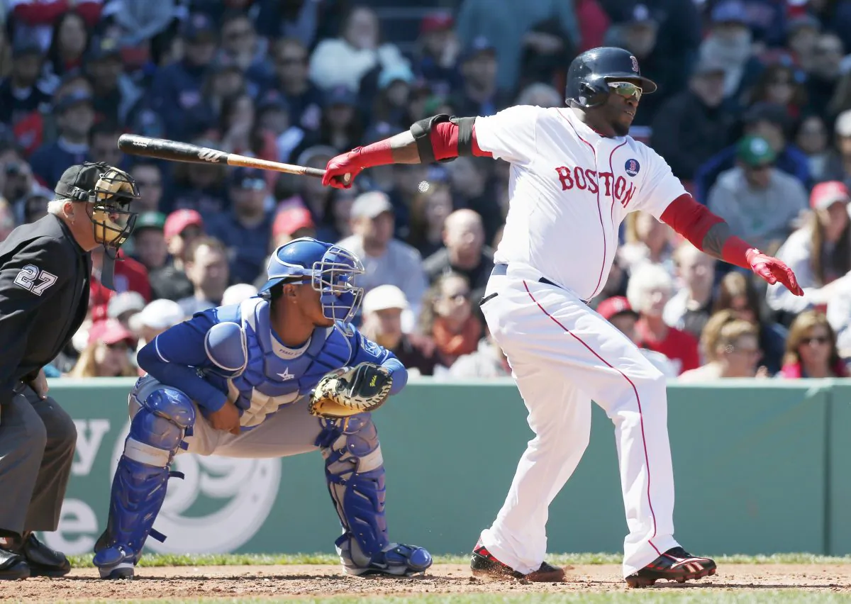 Boston Red Sox's David Ortiz gets an RBI-single in front of Kansas City Royals catcher Salvador Perez, center, in Boston, April 21, 2013. (AP Photo/Michael Dwyer)