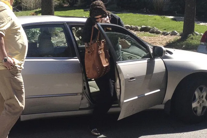 Katherine Russell Tsarnaev, center, wife of dead Boston Marathon bombing suspect Tamerlan Tsarnaev, exits a car at the home of her parents in North Kingstown, R.I. on April 21, 2013. (AP Photo/Katie Zezima)