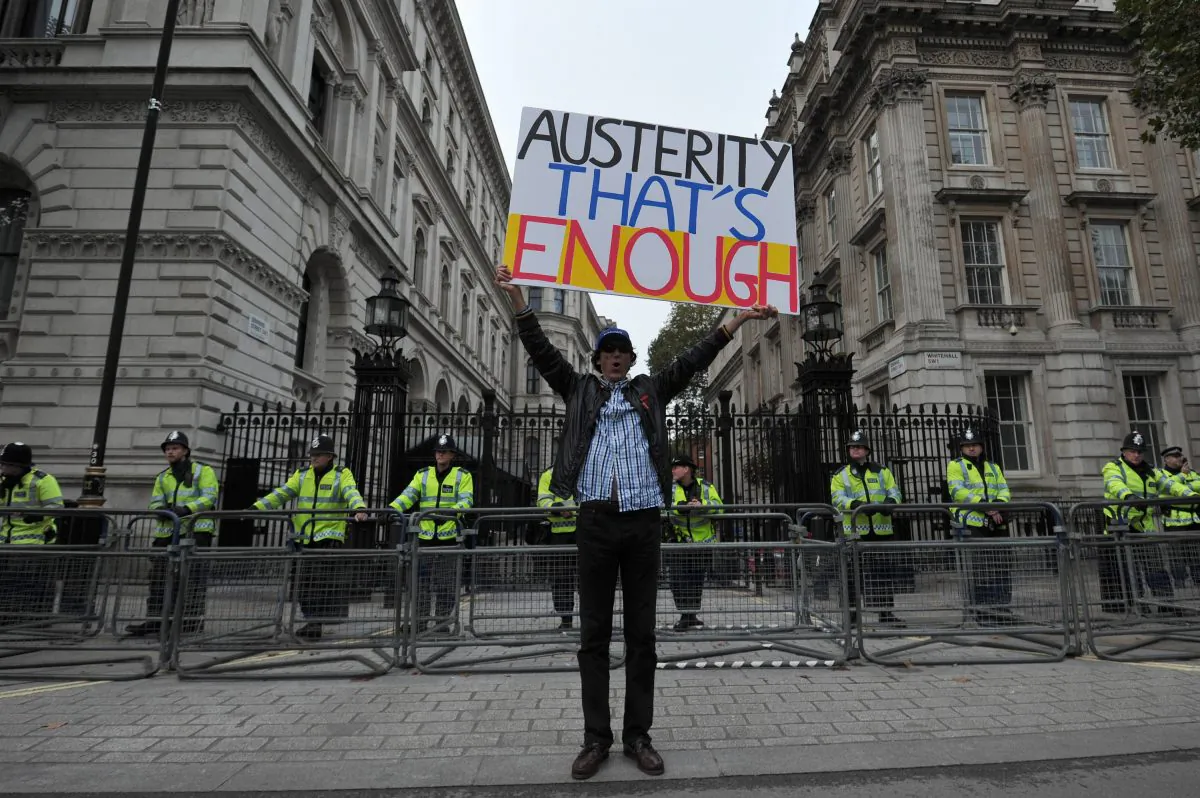 A man demonstrates outside Downing Street in central London on Oct. 20, 2012, against the government's austerity policies and call for an alternative economic strategy that puts jobs and growth first. (Carl Court/AFP/Getty Images)