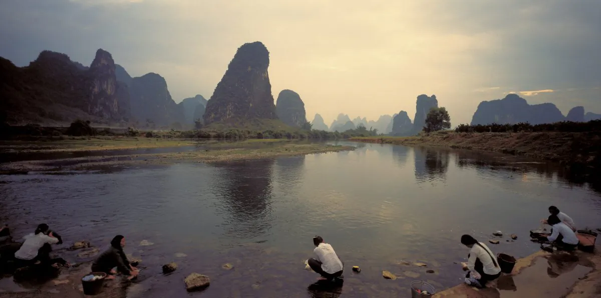 Women wash clothes at a river in rural China. (Hemera Technologies/Photos.com)