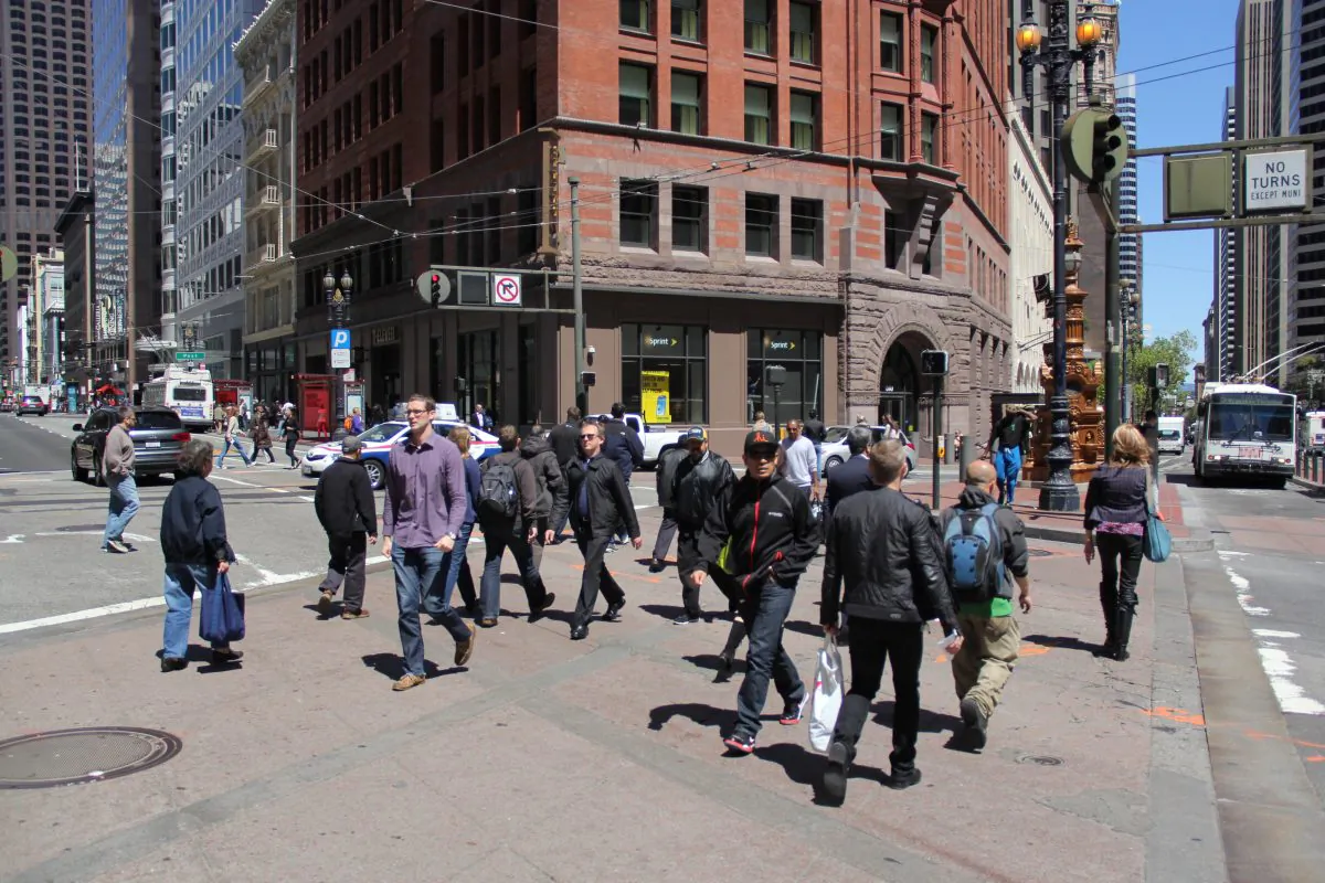 Pedestrians cross an intersection in San Francisco on April 16, 2013. The intersection of Kearny and Market Streets has one of the highest pedestrian fatality and injury rates in the city.
(Christian Watjen/The Epoch Times)