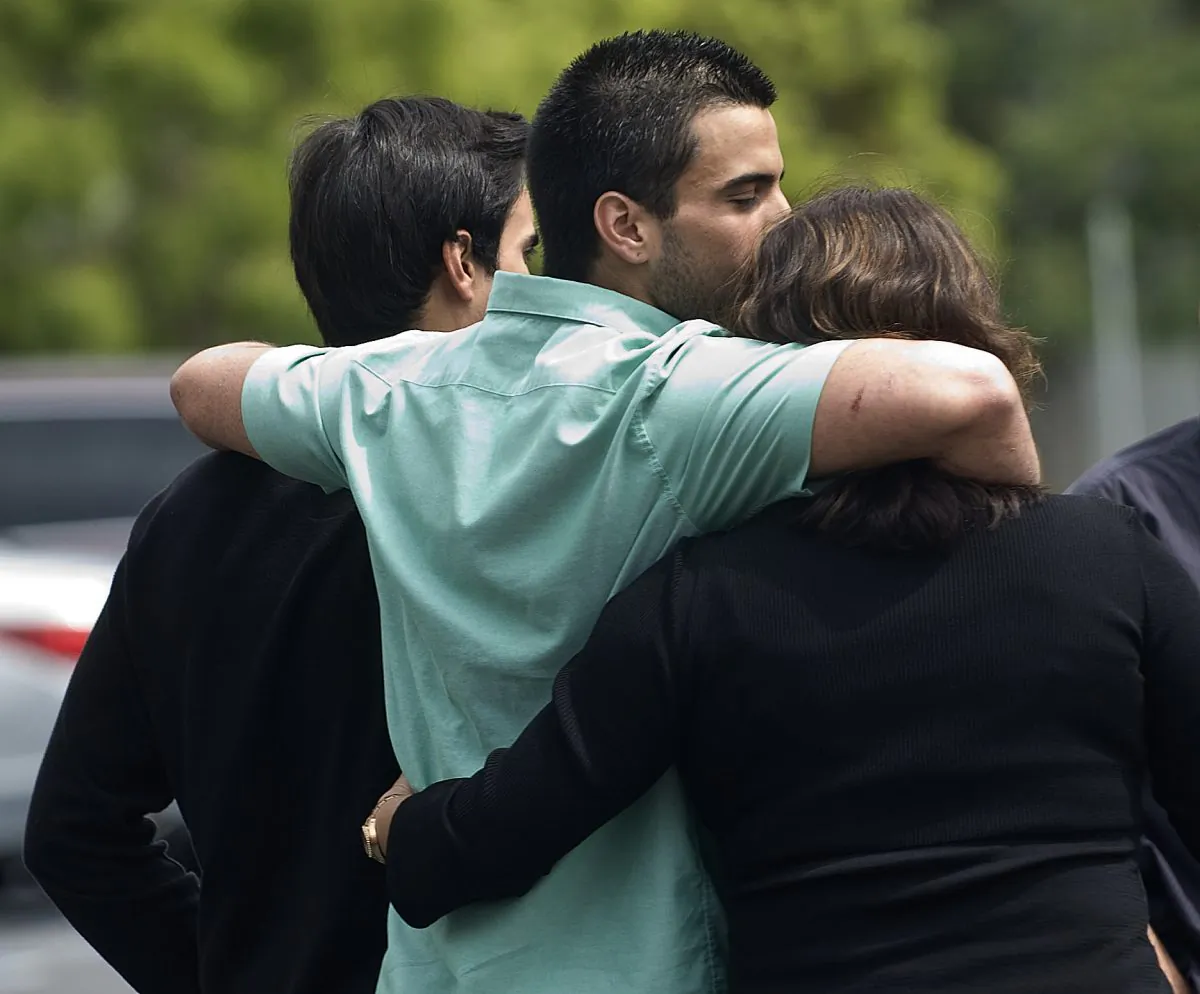Andres Cendoya, from left, his brother Nicolas Cendoya and their mom head to their Costa Mesa home after Nicholas was released from Mission Hospital in Mission Viejo, Calif., on Sunday, April 7. (AP Photo/The Orange County Register, Cindy Yamanaka)