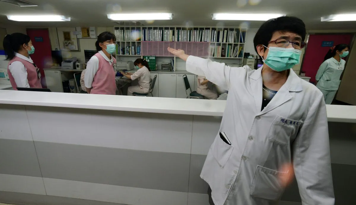 A nurse (R) introduces the front desk for the negative pressure isolation rooms section to treat potential H7N9 avian influenza patients at Taipei Hoping Hospital on April 6, 2013. The island's first case was confirmed on April 24, after a Taiwanese businessman returned from the mainland. (Sam Yeh/AFP/Getty Images)