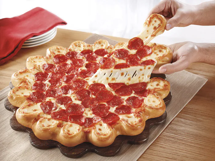 This undated product image provided by Pizza Hut shows the company's new pizza crust made of little cheese-stuffed bread bowls. (AP Photo/Pizza Hut)