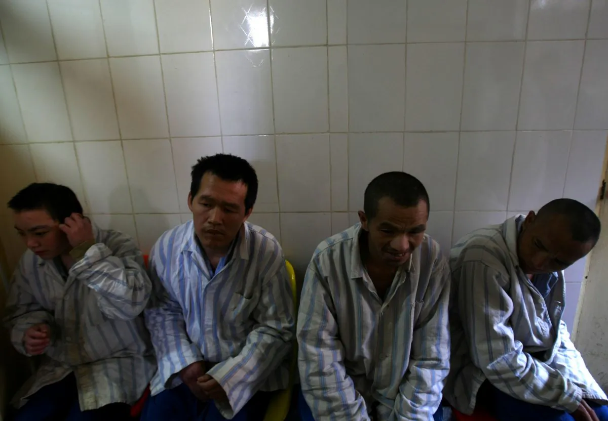 Patients wait to eat in the Kunming Mental Hospital on Dec. 1, 2007 in Kunming of Yunnan Province, southwest China. The Chinese authorities are rolling out a new mental health law, but many doubt it will really prevent the abuses that it is supposed to. (China Photos/Getty Images)