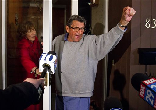 This Nov. 9, 2011 file photo shows Penn State coach Joe Paterno and his wife Sue on the front porch of their house, addressing students. Sue Paterno says she and her husband were ignorant about sexual predators like Jerry Sandusky. (AP Photo/The Patriot-News, Joe Hermitt)
