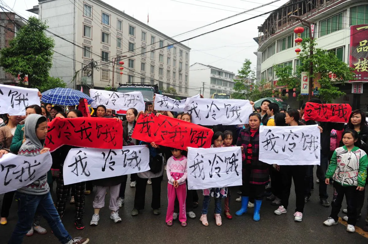 After an earthquake struck southwest China's Sichuan Province, residents in Lingguan township of Baoxing county gather on the street with banners saying 'I am cold and hungry' to appeal for support and to draw attention the shortage of relief supplies, on April 23, 2013. The Communist Party has been preventing volunteers from assisting victims in case the true number of casualties and the poor construction of the buildings is revealed. (AFP/Getty Images) 