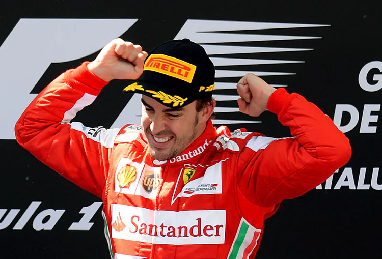 Ferrari's Spanish driver Fernando Alonso celebrates on the podium of the Formula One Spanish Grand Prix at the Circuit de Catalunya in Montmelo near Barcelona on May 12. (Lluis Gene/AFP/Getty Images)