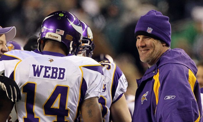 Quarterback Brett Favre (R) #4 congratulates Joe Webb #14 of the Minnesota Vikings after scoring a touchdown in 2010. Favre should be brought back to the Packers, and his jersey should be retired, says the Packers CEO. (Jim McIsaac/Getty Images)