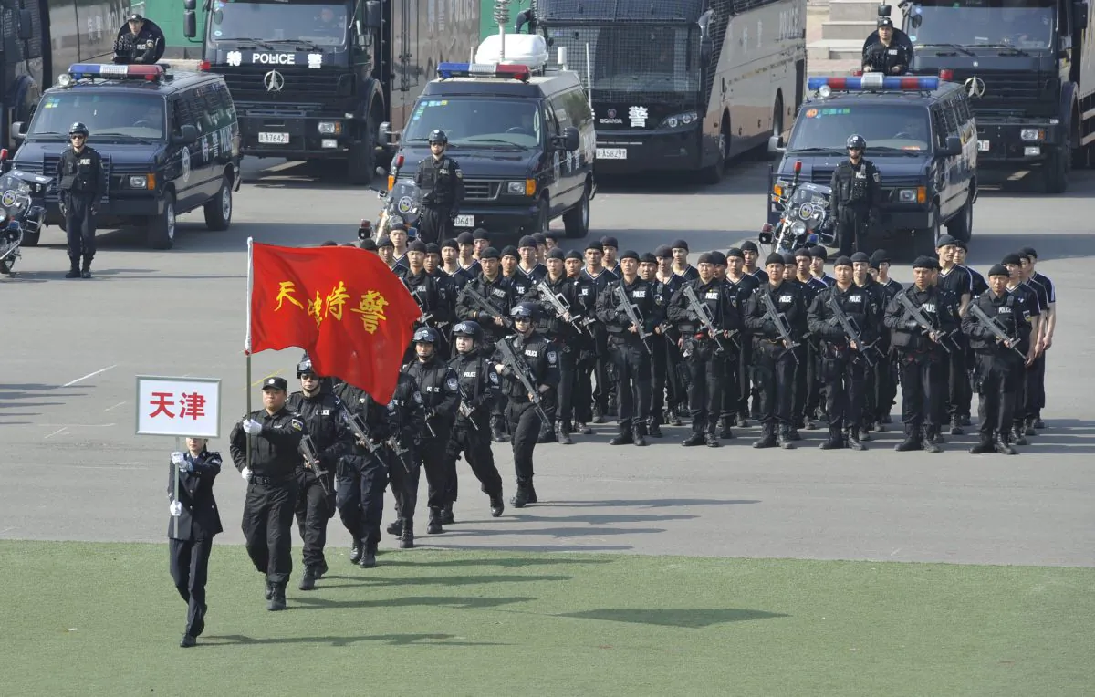 A team of Chinese special tactical police march during a demonstration in Beijing on April 12, 2011. According to a Defense White Paper, the Chinese regime deployed military police officers to handle domestic distrubances more than 1.6 million times in 2012, which He Qinglian says is a sign the regime and the people have become enemies
