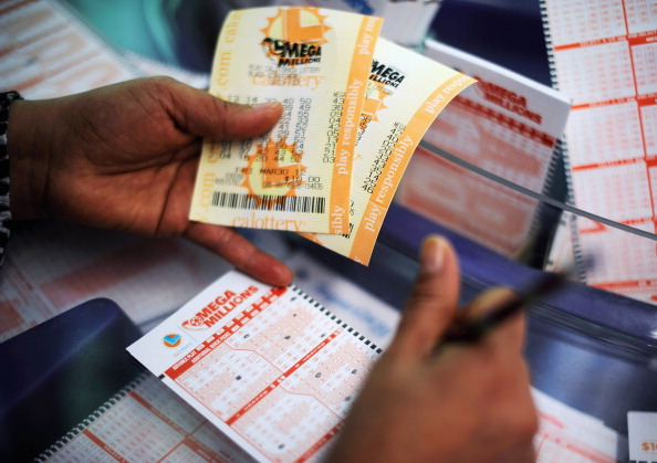 A woman fills out a Mega Millions lottery ticket form at Liquorland on March 30, 2012 in Covina, California. (Kevork Djansezian/Getty Images)