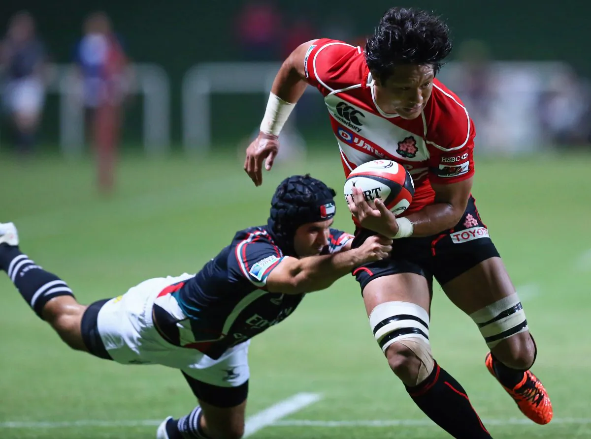 Japan's Takashi Kikutani escapes a tackle during the Asian Five Nations rugby match against UAE at the Sevens stadium in the Gulf emirate of Dubai on May 10, 2013. Japan's dominant 93-3 victory over UAE gave them a clean sweep in the series. (MARWAN NAAMANI/AFP/Getty Images)