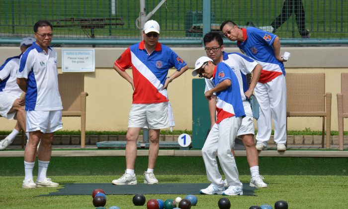 Both the Hong Kong Football Club (in white) and Kowloon Bowling Green Club members get anxious during the Premier League encounter. KBGC emerged with a 6:2 victory. (Stephanie Worth)
