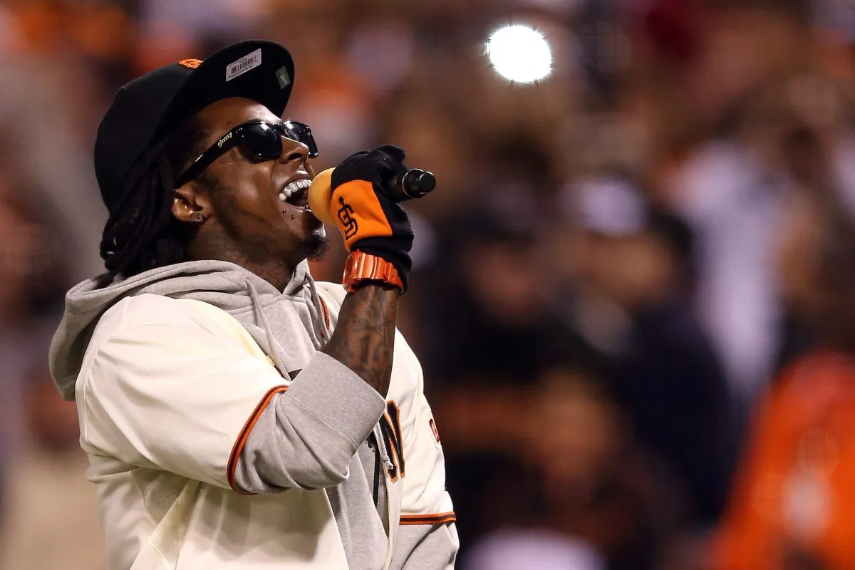 Rapper Lil Wayne sings last fall during a baseball game. The rapper was hospitalized due to a seizure, though he later said he's fine. (Ezra Shaw/Getty Images)