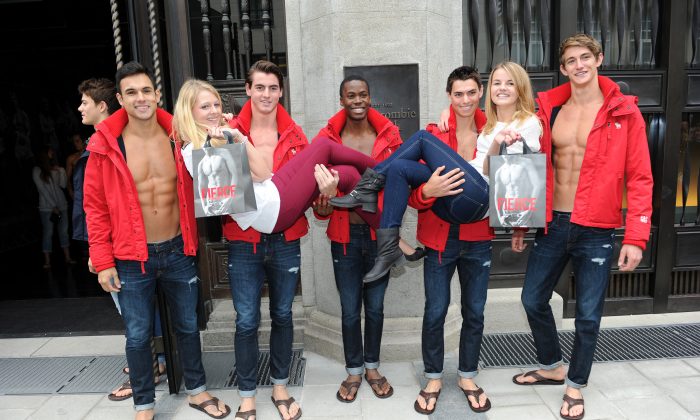 Young women pose for photographs with male models outside the Abercrombie & Fitch flagship clothing store during the opening of Abercrombie & Fitch Munich flagship store on October 25, 2012 in Munich, Germany. The clothing company has been criticized for catering to "cool, good-looking people." (Hannes Magerstaedt/Getty Images)