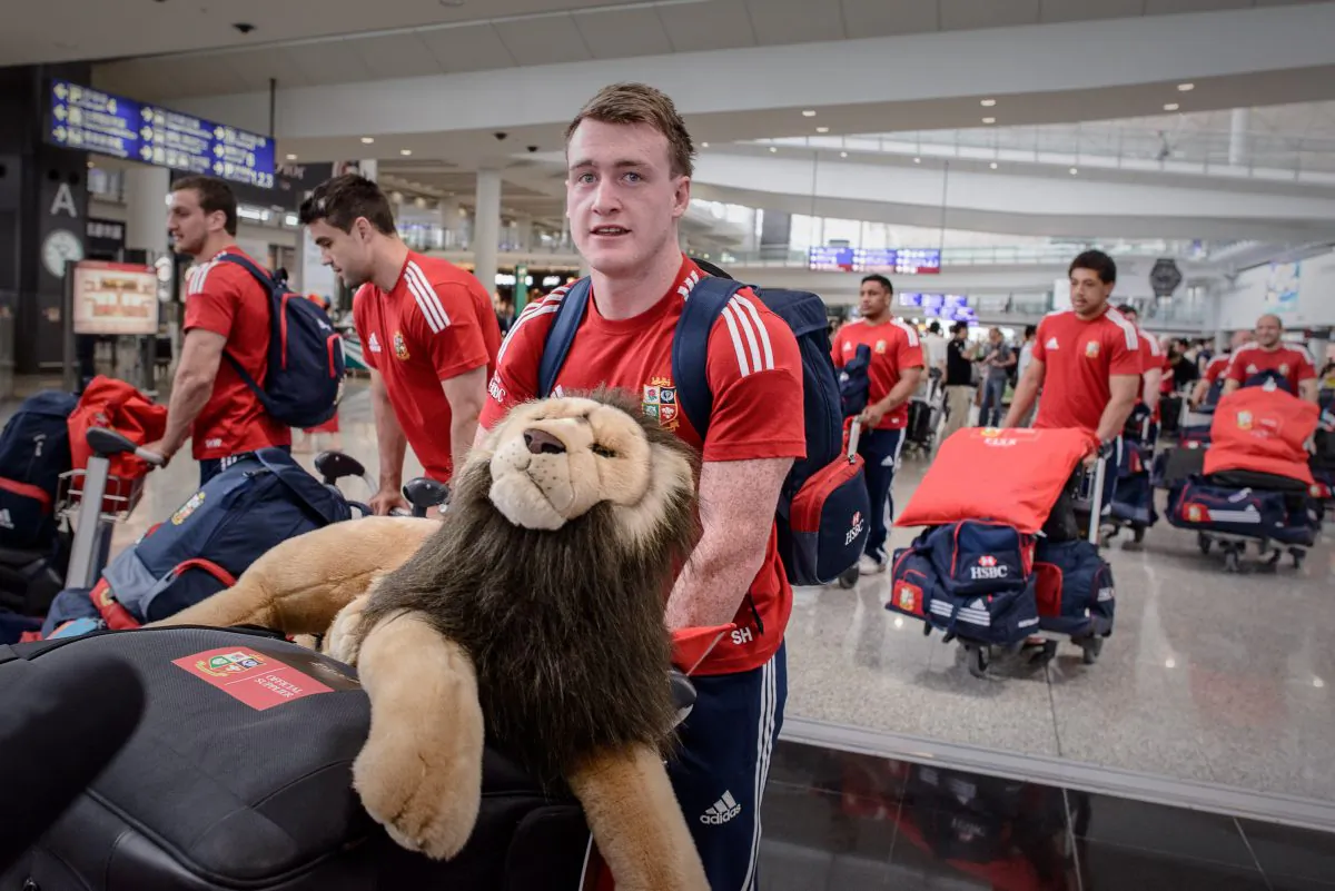 Scottish full-back Stuart Hogg carries the mascot of the British and Irish Lions as he and his team-mates arrive at Hong Kong airport on May 28, 2013. (PHILIPPE LOPEZ/AFP/Getty Images)