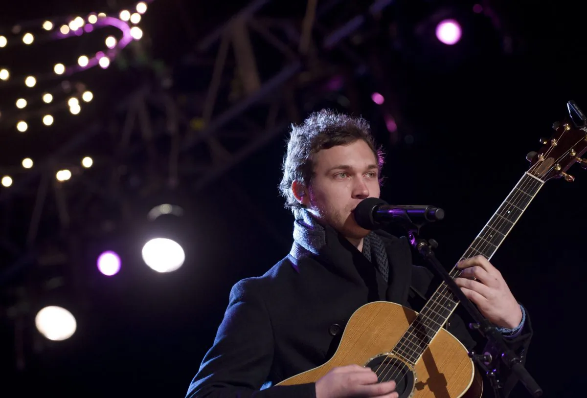 American Idol season 11 winner Phillip Phillips performs during the National Christmas Tree Lighting on the Ellipse adjacent to the White House in Washington, DC, on December 6, 2012. Phillips postponed the last several dates on his tour. (Saul Loeb/AFP/Getty Images)