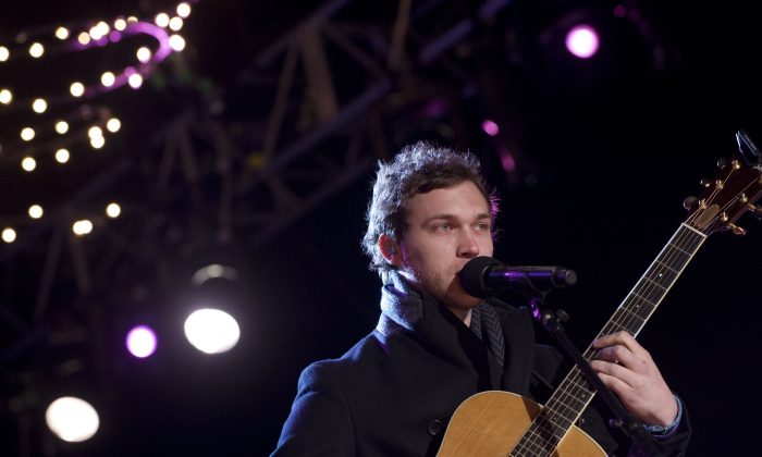 American Idol season 11 winner Phillip Phillips performs during the National Christmas Tree Lighting on the Ellipse adjacent to the White House in Washington, DC, on December 6, 2012. Phillips postponed the last several dates on his tour. (Saul Loeb/AFP/Getty Images)
